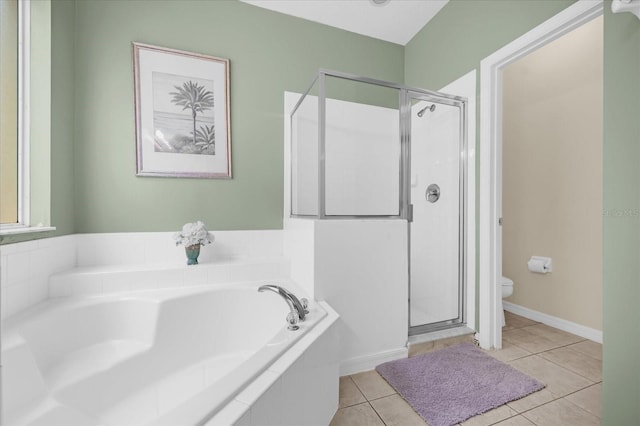 bathroom featuring tile patterned floors, toilet, and independent shower and bath