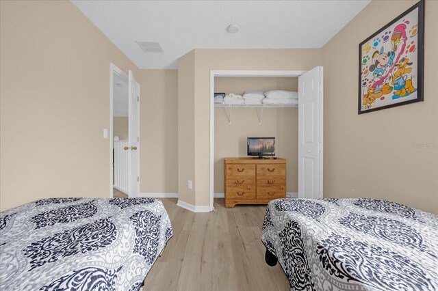 bedroom featuring a closet and light hardwood / wood-style flooring