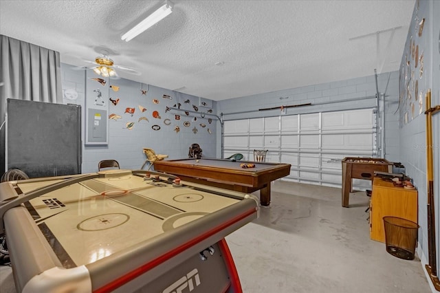 playroom with ceiling fan, electric panel, concrete floors, a textured ceiling, and pool table