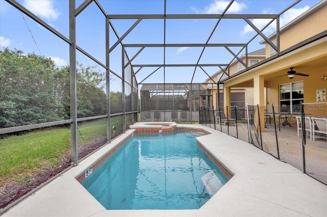 view of pool with ceiling fan, a lanai, an in ground hot tub, and a patio