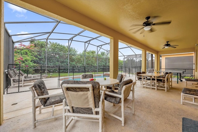 view of patio / terrace with ceiling fan and glass enclosure