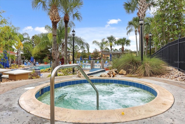 view of swimming pool with a community hot tub and sink