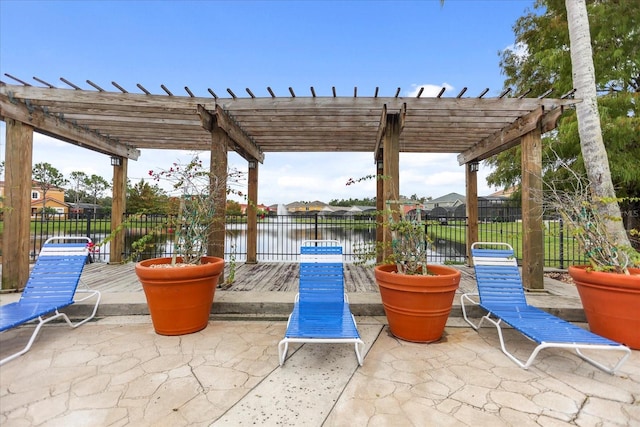 view of patio / terrace with a pergola and a water view