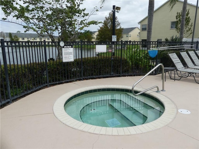 view of swimming pool with a community hot tub and a water view