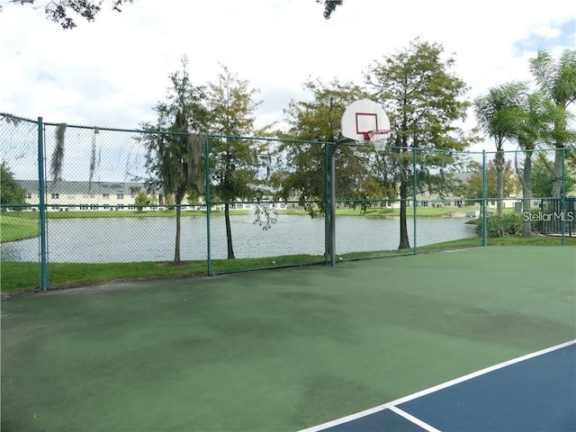 view of basketball court featuring a water view