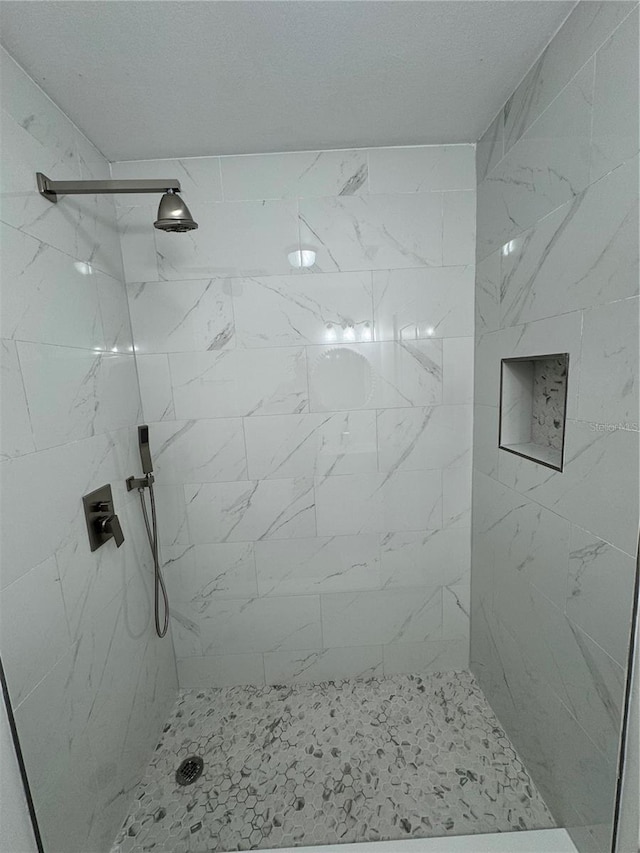 bathroom with a tile shower