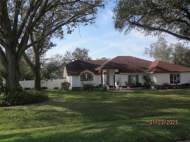 ranch-style home with a front lawn