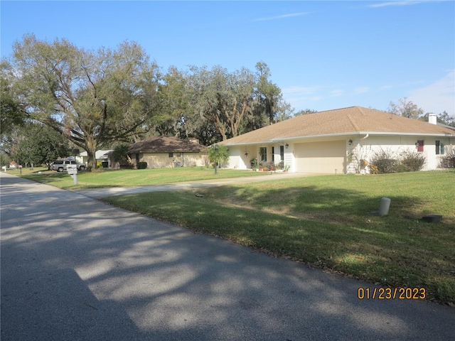 view of front facade with a front lawn and a garage