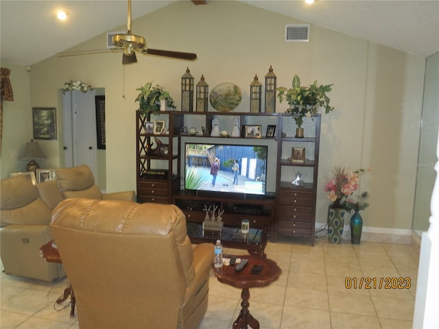 tiled living room with ceiling fan and lofted ceiling