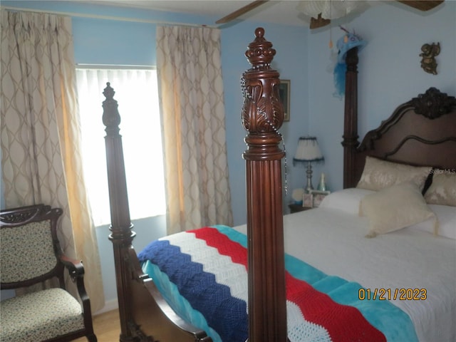 bedroom featuring multiple windows, ceiling fan, and hardwood / wood-style floors