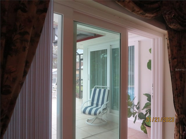 doorway to outside with plenty of natural light and light tile patterned flooring