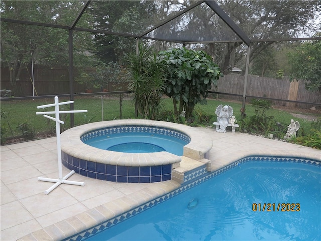 view of pool featuring a lanai, a patio, and an in ground hot tub