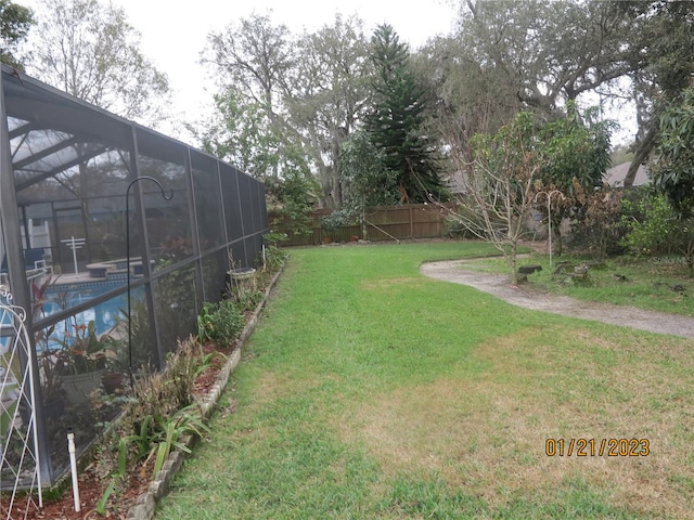 view of yard with glass enclosure