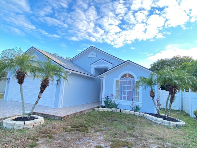 view of front of house with a garage and a front lawn