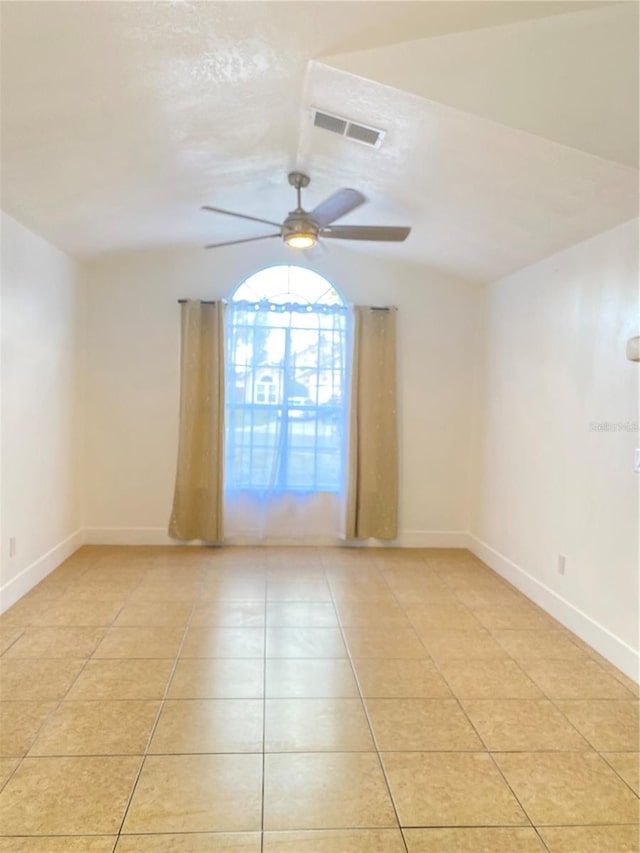 tiled spare room with ceiling fan and lofted ceiling