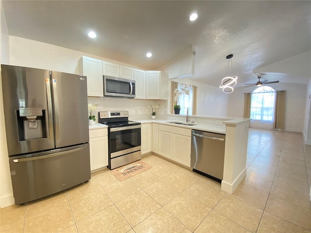 kitchen with pendant lighting, kitchen peninsula, vaulted ceiling, appliances with stainless steel finishes, and white cabinetry