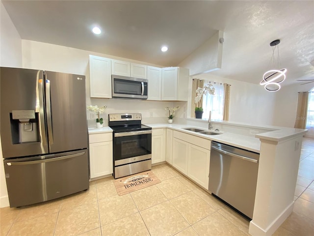 kitchen featuring kitchen peninsula, stainless steel appliances, sink, light tile patterned floors, and white cabinetry