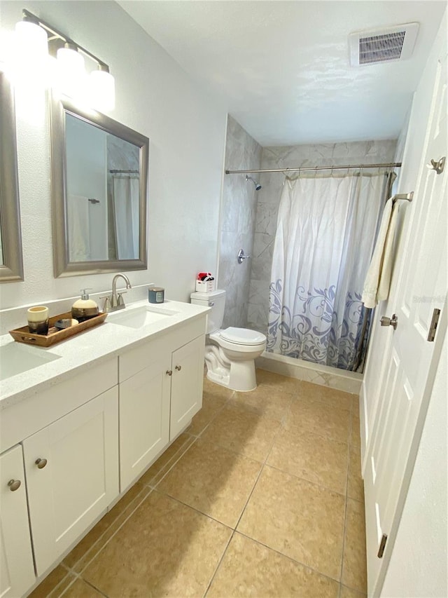 bathroom with tile patterned floors, vanity, curtained shower, and toilet