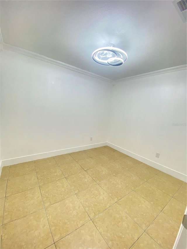 empty room featuring tile patterned floors and ornamental molding