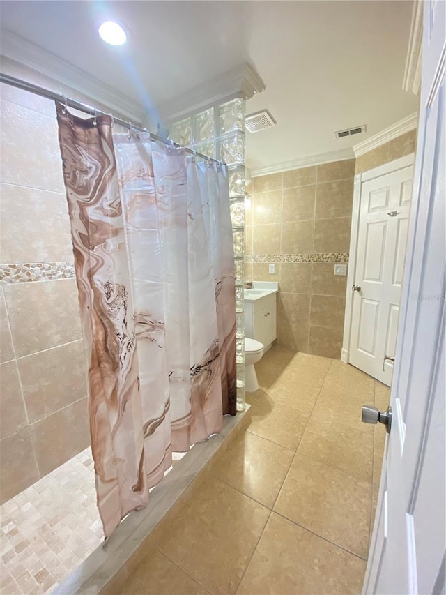 full bathroom with tile patterned floors, ornamental molding, vanity, shower / tub combo with curtain, and tile walls