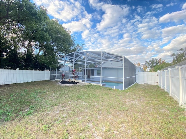 view of yard with a lanai and a fenced in pool