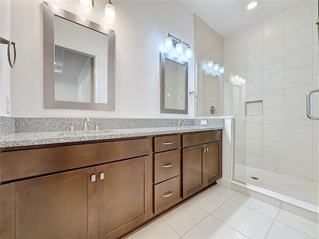 bathroom featuring vanity, tile patterned floors, and a shower with door