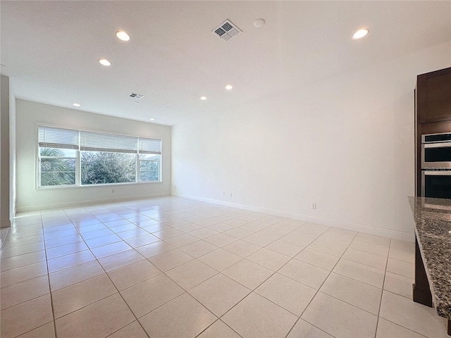 empty room with light tile patterned floors