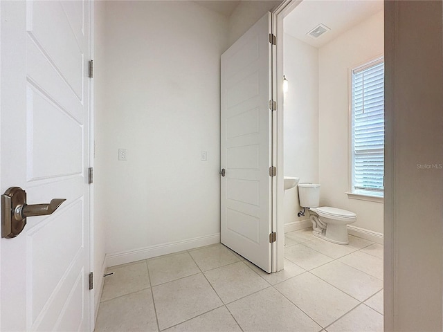 bathroom featuring tile patterned flooring and toilet