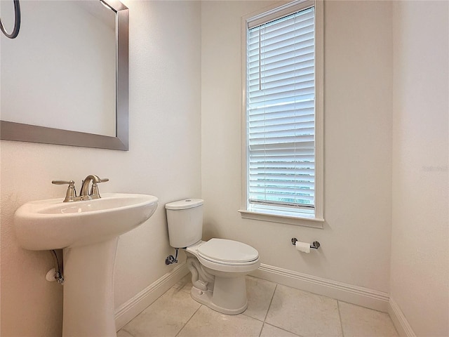 bathroom with tile patterned floors, toilet, and sink