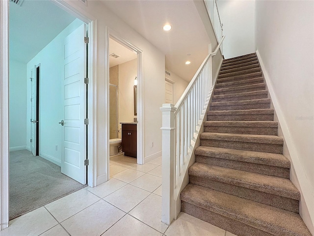 stairs featuring tile patterned flooring