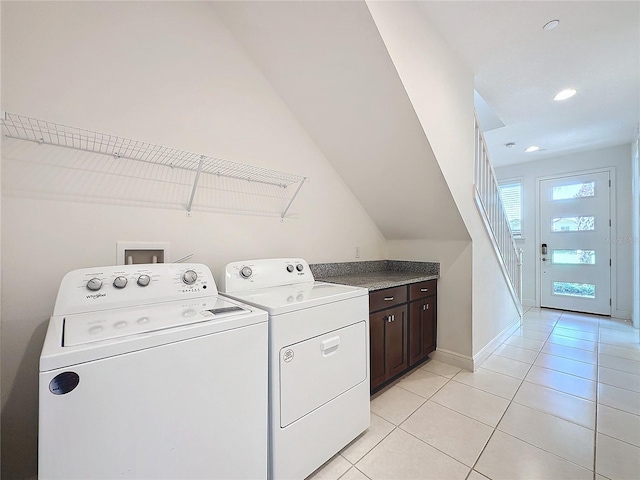 clothes washing area with washing machine and dryer and light tile patterned floors