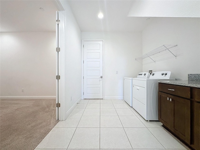 laundry area featuring light carpet and washer and clothes dryer