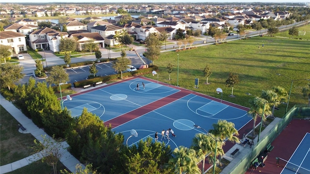 view of basketball court with a lawn