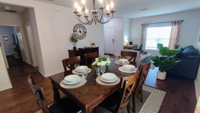 dining room with dark hardwood / wood-style floors and an inviting chandelier