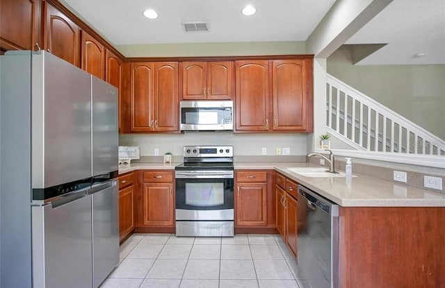 kitchen featuring light tile patterned floors, sink, and appliances with stainless steel finishes