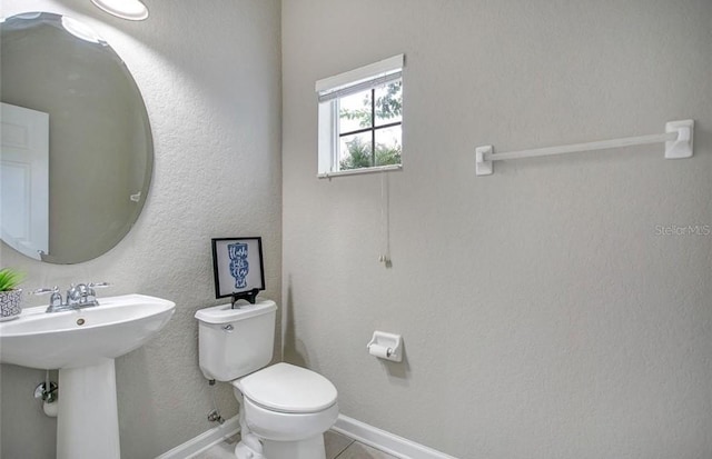 bathroom featuring tile patterned floors, sink, and toilet