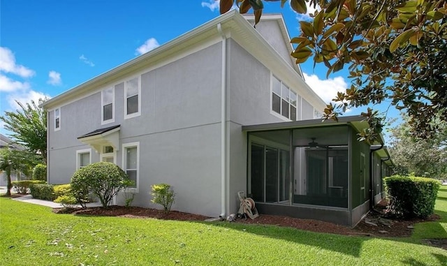 back of property featuring a sunroom and a yard