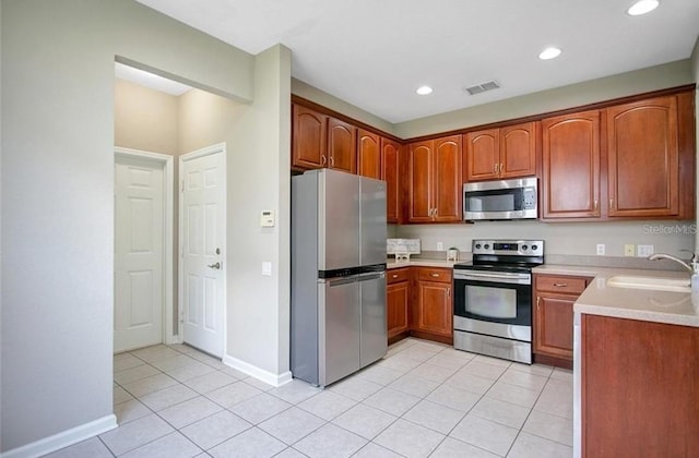 kitchen featuring light tile patterned floors, sink, and appliances with stainless steel finishes