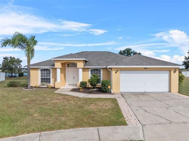 single story home with a front yard and a garage