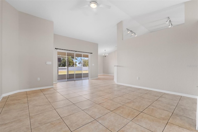 spare room with ceiling fan with notable chandelier, light tile patterned floors, and rail lighting