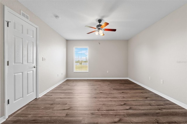 unfurnished room featuring dark hardwood / wood-style floors and ceiling fan