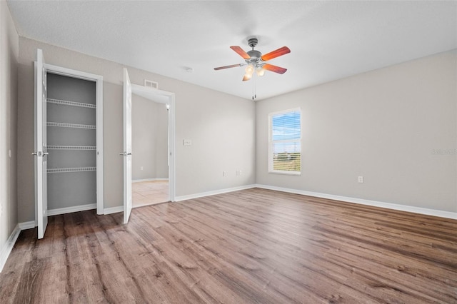 unfurnished bedroom featuring light wood-type flooring and ceiling fan