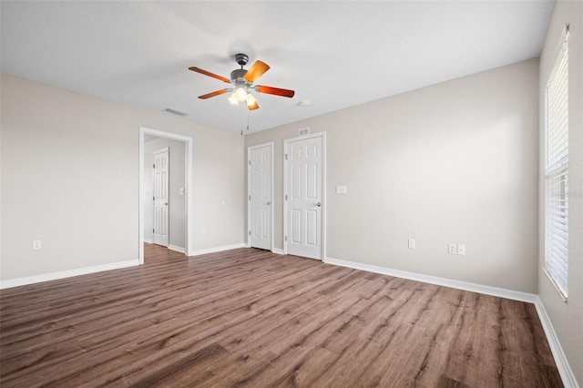 unfurnished bedroom with ceiling fan and hardwood / wood-style flooring