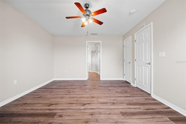 spare room with ceiling fan and hardwood / wood-style flooring