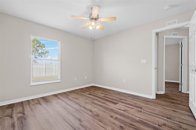 unfurnished room featuring hardwood / wood-style floors and ceiling fan