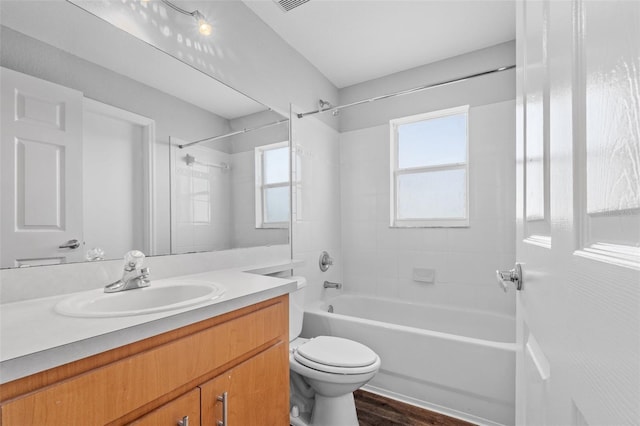 full bathroom featuring wood-type flooring, vanity, toilet, and tiled shower / bath