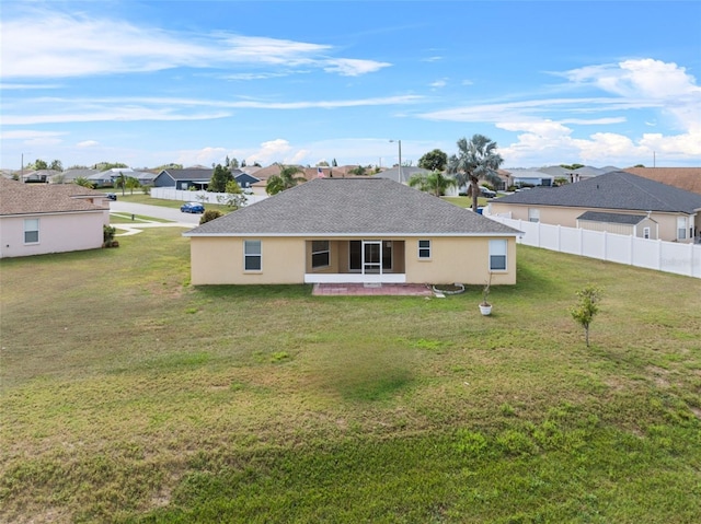 rear view of property featuring a yard and a patio