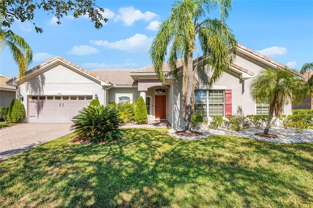 mediterranean / spanish house featuring a garage and a front yard