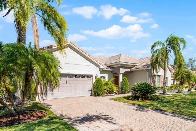 view of front of house featuring a garage and a front lawn