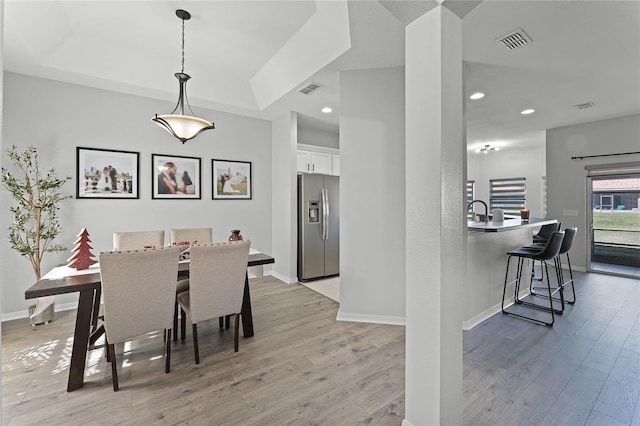 dining area featuring light wood-type flooring